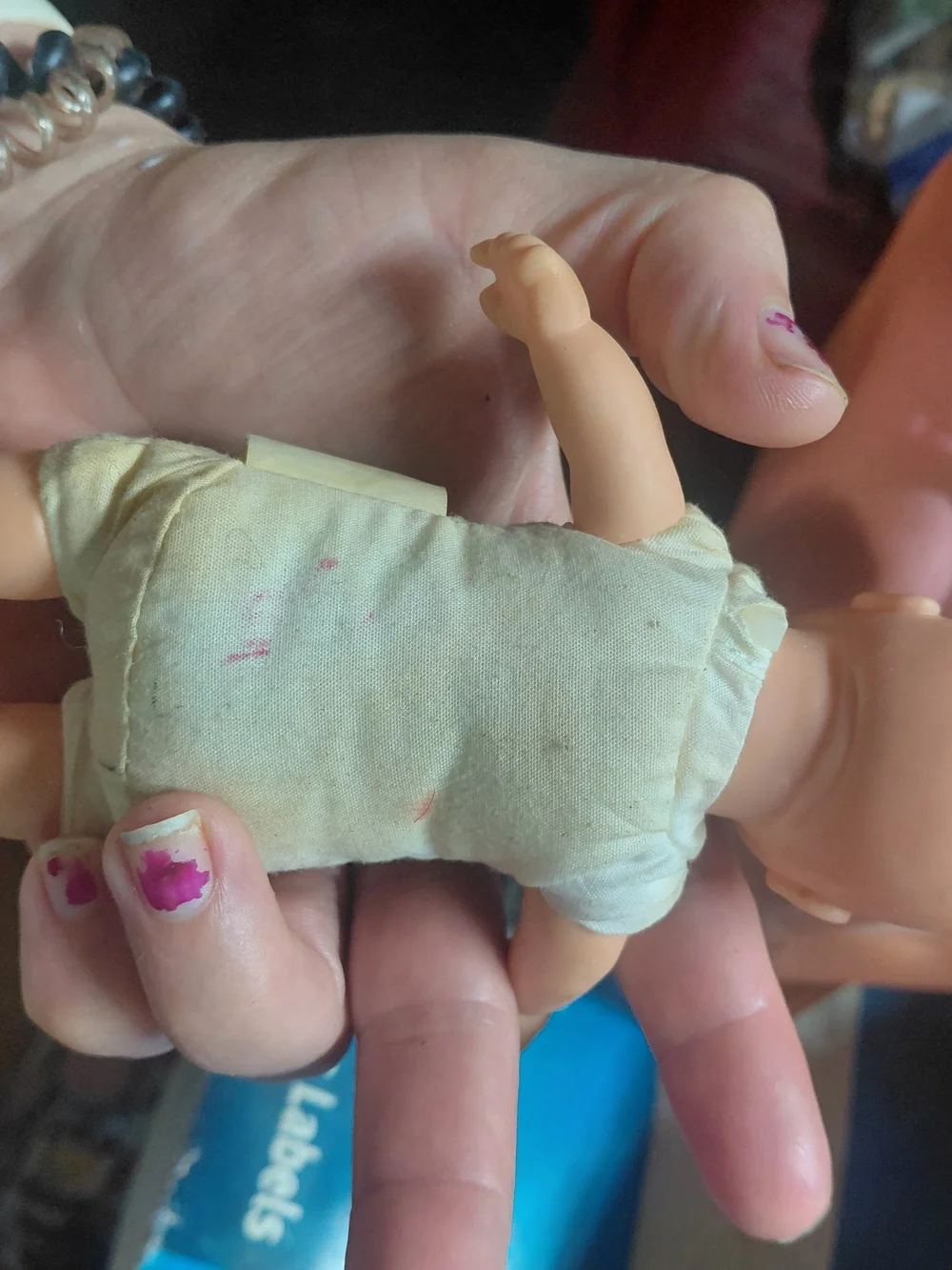 a vintage 1997 Corolle mini baby doll featuring blue eyes and a soft body.